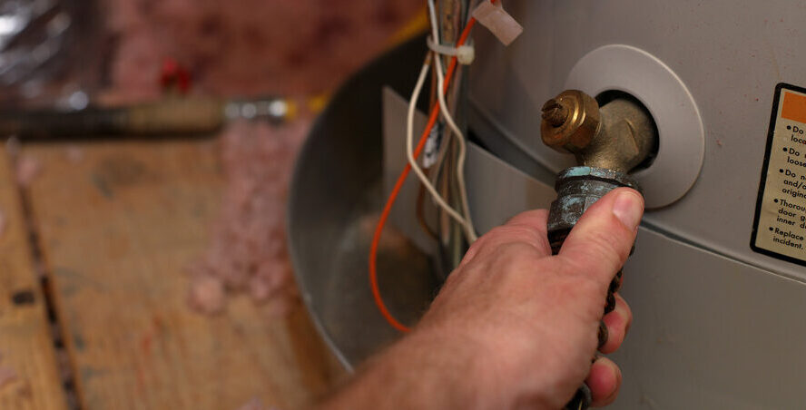 Man performing water heater repairs