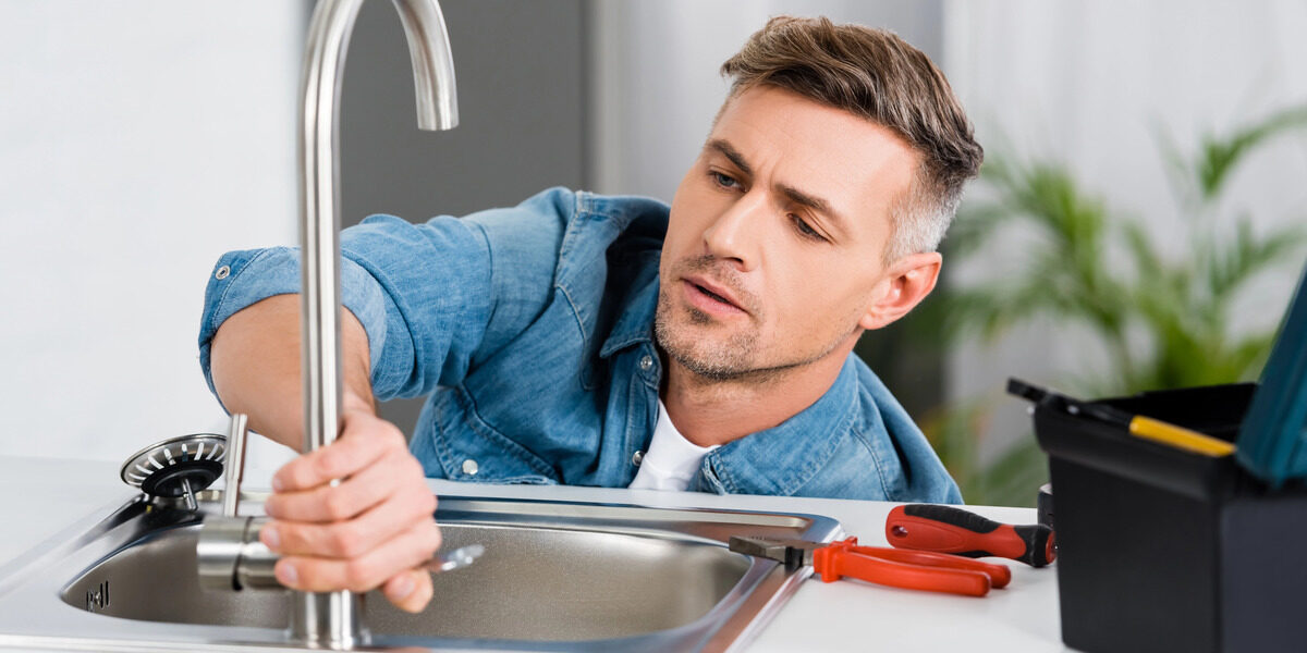 plumber installing water filtration system